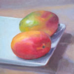 Two Mangoes on a plate